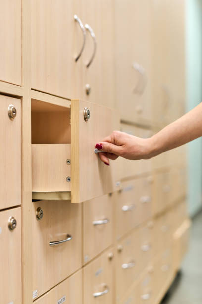 istock Pharmacist opening wooden drawer in bright pharmacy setting 2200013842