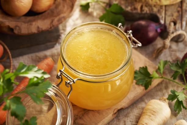 istock Bone broth in a glass jar with fresh vegetables 2200016030