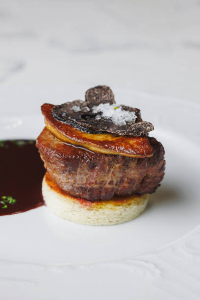 istock Appetizing medallion with foie gras, truffle and sauce on a large white plate 2200016736