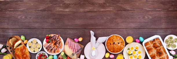istock Easter breakfast or brunch bottom border. Top down view on a dark wood banner background. 2200017114