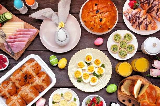 istock Easter breakfast or brunch table scene. Overhead view on a dark wood background. 2200017160