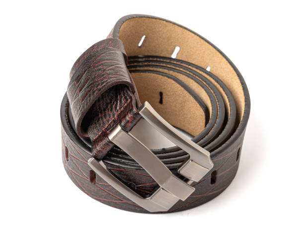 istock Brown leather belt with metal buckle rolled up on white background 2200017439