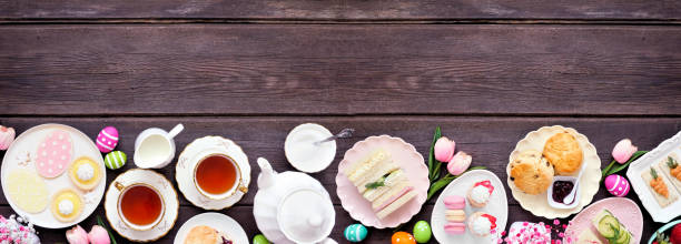 istock Easter or spring tea bottom border against a dark wood banner background 2200018517