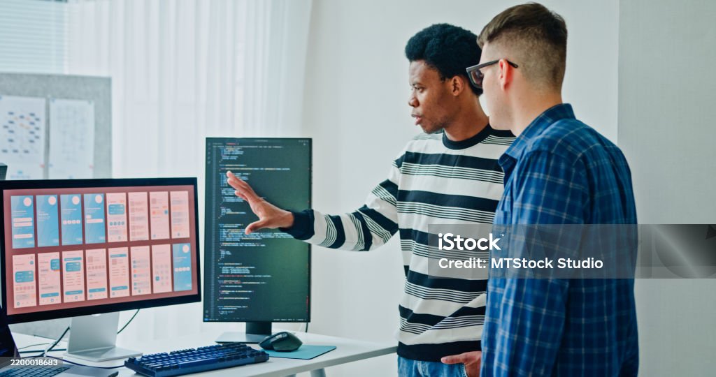 Two Male Software Developers Meeting On Multiple Computer Screens ...
