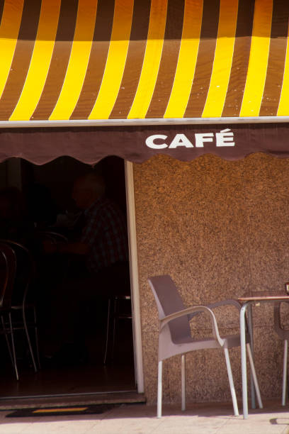 Awning with cafe commercial sign covering a sidewalk cafe. Antas de Ulla, Lugo province, Galicia, Spain.