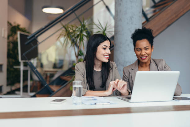 istock Businesswomen collaborating on a project using a laptop in the office 2200020691