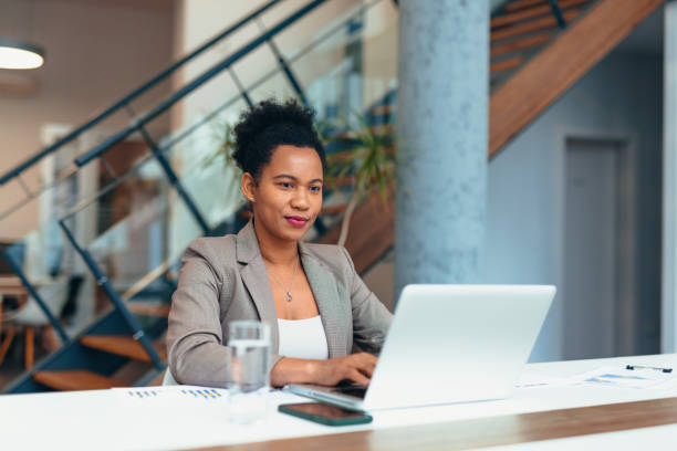istock Confident young businesswoman working on laptop in modern office 2200020708