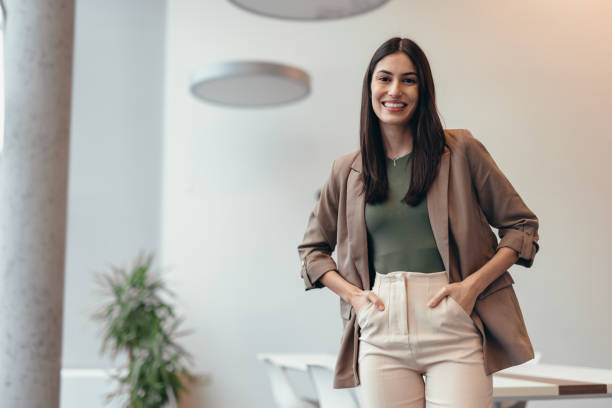 istock Confident young businesswoman smiling in modern office space 2200020772