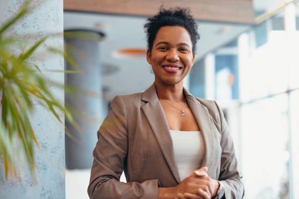 istock Confident businesswoman smiling in modern office environment 2200020971