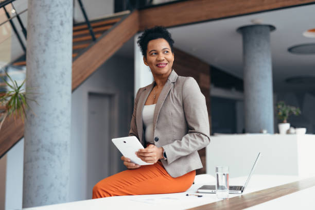 istock Smiling businesswoman using digital tablet in modern office 2200021003