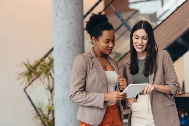 istock Two businesswomen collaborating on a project using a tablet in a modern office 2200021069