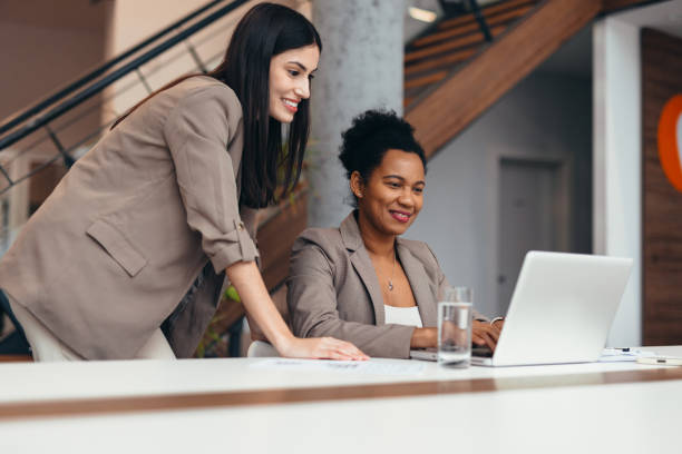 istock Two businesswomen collaborating on a project using a laptop in the office 2200021116