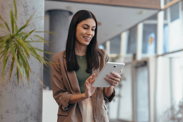 istock Young businesswoman using digital tablet in modern office 2200021876