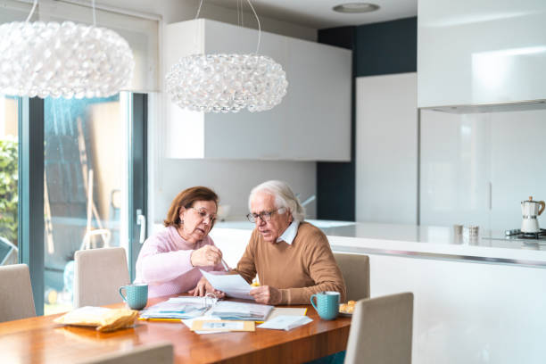 istock Senior Hispanic Couple Managing Finances at Home 2200023015