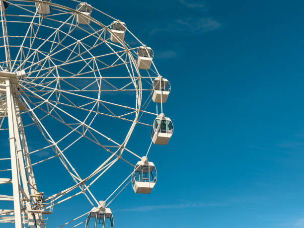 istock White ferris wheel against a clear blue sky in Figueira da Foz 2200029538