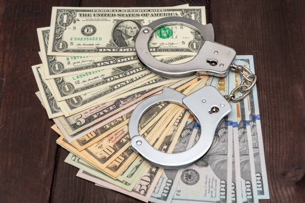 istock Financial crimes: money and handcuffs in one shot. 2200030784