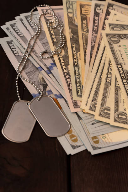 istock Military identification token on U.S. banknotes - a concept for military pay and pensions. 2200030809