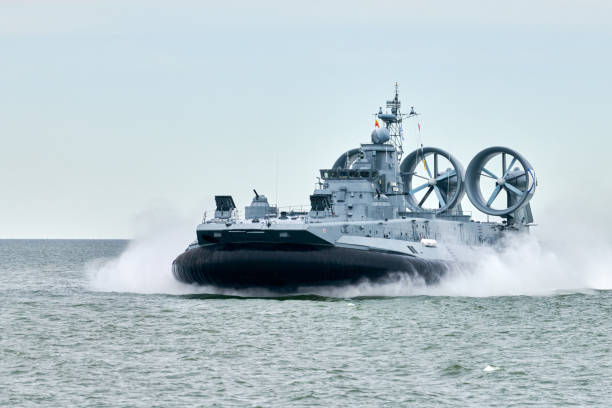 istock Hovercraft warship armed with armament sails into sea toward military target to attack and destroy 2200032191