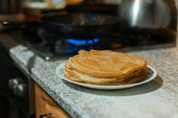 There's a stack of hot pancakes on the table.