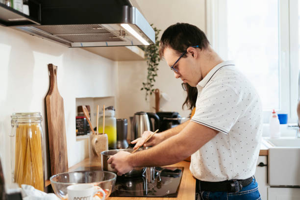 istock Young people both with Down Syndrome, cooking together 2200034162