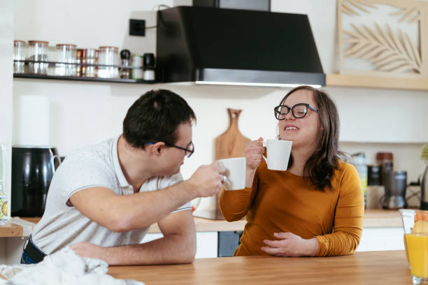 istock Young people with Down Syndrome drinking coffee at home 2200034291