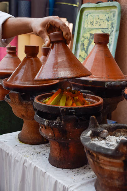 istock Hand lifting a tagine while cooking with delicious typical Marrakesh food inside 2200047086