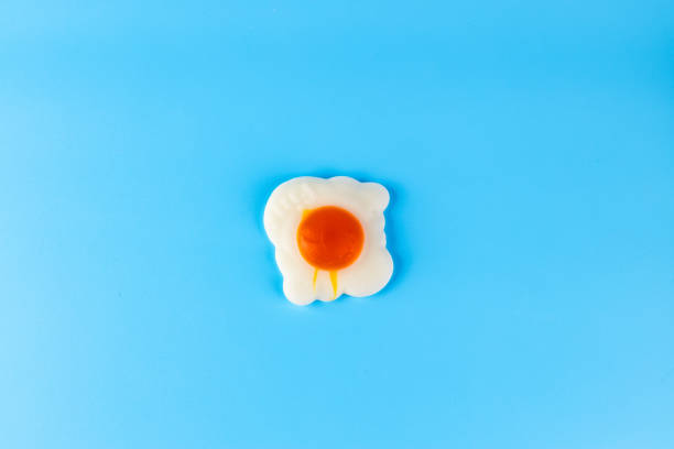istock A Colorful Representation of a Fried Egg on a Vibrant Blue Background Perfect for Kitchen Decor and Food-themed Designs 2200047354