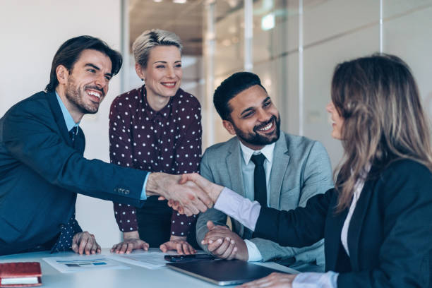 istock Businesswoman shaking hands with a coworker in office work space 2200048196