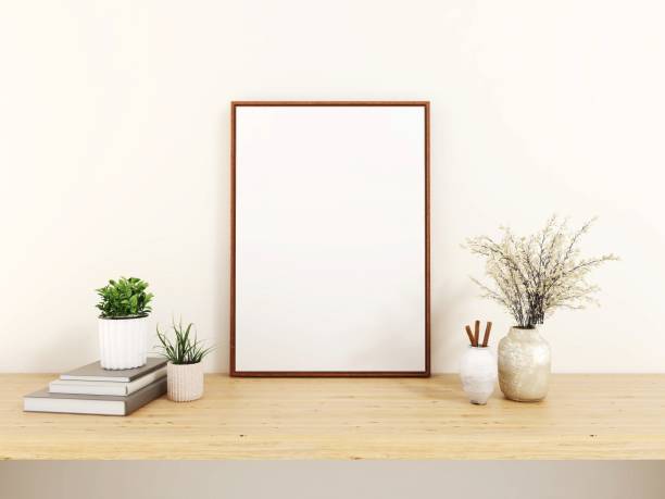 istock Blank vertical frame mockup, ornaments, plants and books on a table 2200051034