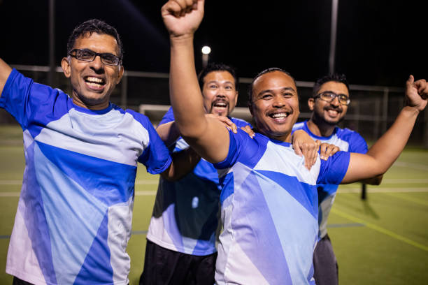 istock Soccer Players Enjoying Post-Match Victory Celebration 2200052486