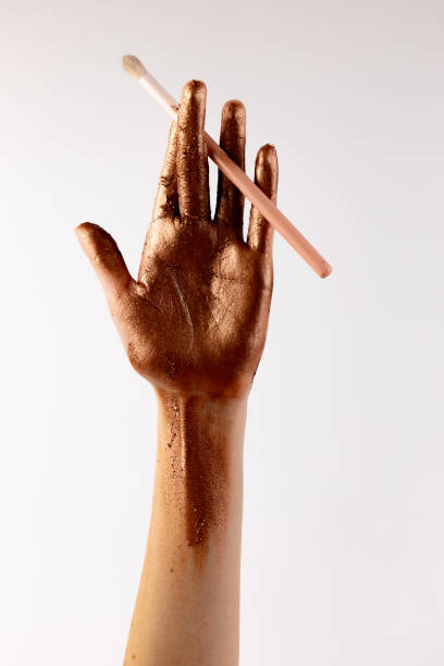 istock Aesthetic Bronze Hand with Makeup Brush: Captivating Elegance and Artistry on Display for Beauty and Cosmetic Inspiration 2200052549