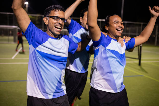 istock Soccer Players Enjoying Post-Match Victory Celebration 2200052551