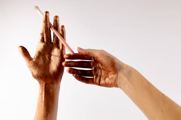 istock Artistic Hands Aesthetics Featuring Glittering Bronze Pigment and Makeup Brush, Emphasizing Beauty and Creativity in Makeup Application and Artistic Expression in Unique Style 2200052594