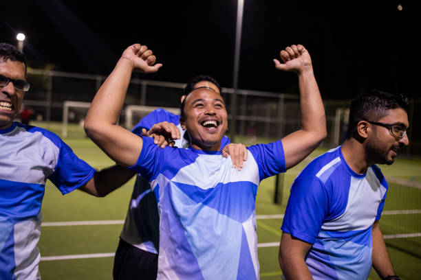 istock Soccer Players Celebrating Win After Game 2200052682