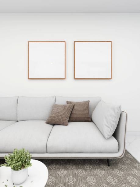 istock Simple living room with a white sofa, ornaments and two blank square frames 2200052919