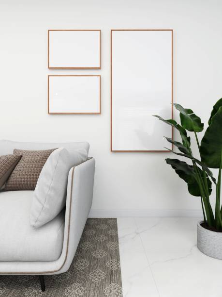 istock Simple living room with white sofa, ornaments and three blank frames 2200052931