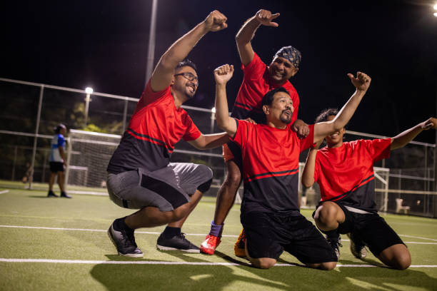istock Soccer Player Celebrating a Goal With Teammates 2200053191