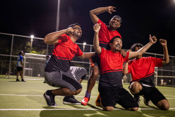 istock Soccer Player Celebrating a Goal With Teammates 2200053228