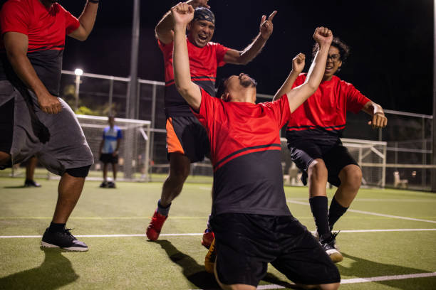 istock Soccer Player Celebrating a Goal With Teammates 2200053262
