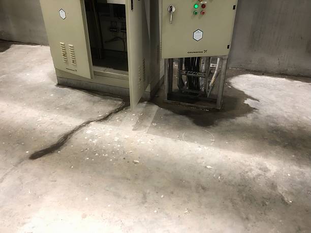 istock This image shows rainwater seepage flowing across a concrete floor from behind an open electrical cabinet or panel 2200053380