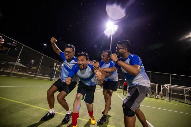 istock Soccer Team Celebrating a Goal Together 2200054284