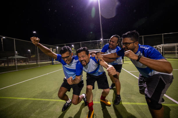 istock Soccer Team Celebrating a Goal Together 2200054323