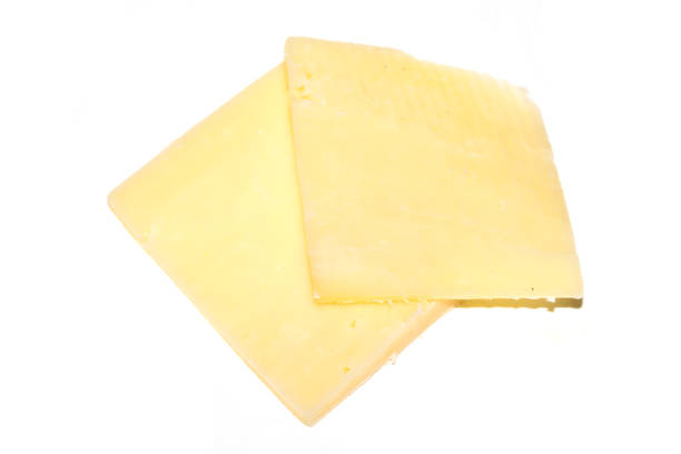 istock Close up of chedder cheese slices on a white background 2200054404