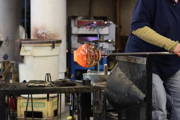 istock Glass blowing technique to shape a bowl from hot glass 2200055781