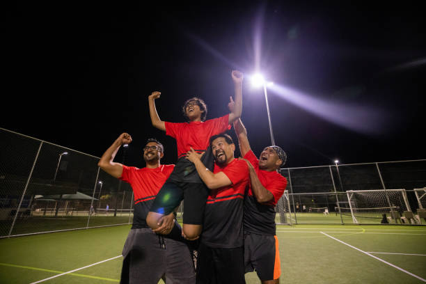 istock Soccer Players Carrying Teammate with Pride 2200055833