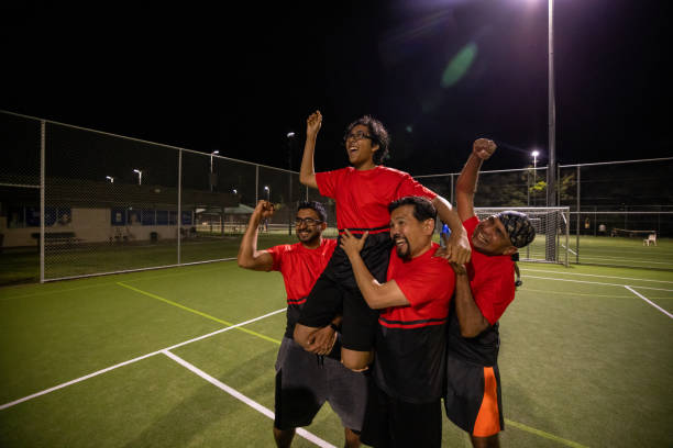 istock Soccer Players Carrying Teammate with Pride 2200055877