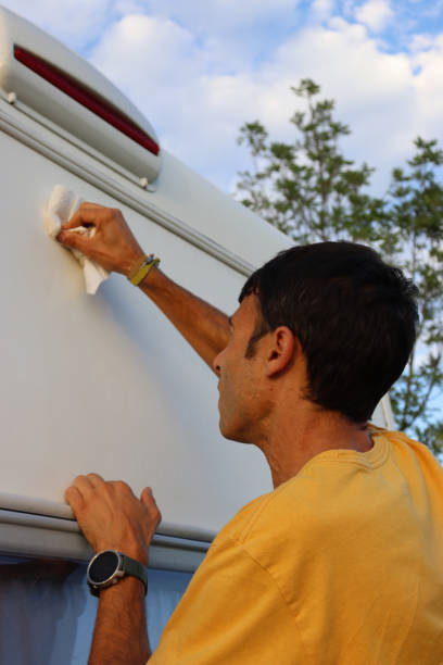 istock Camper cleaning motorhome exterior on a sunny day. 2200055994