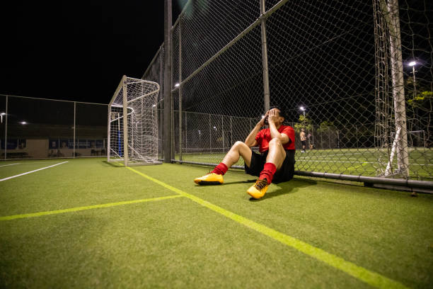 istock Frustrated Soccer Player After a Lost Match 2200056019