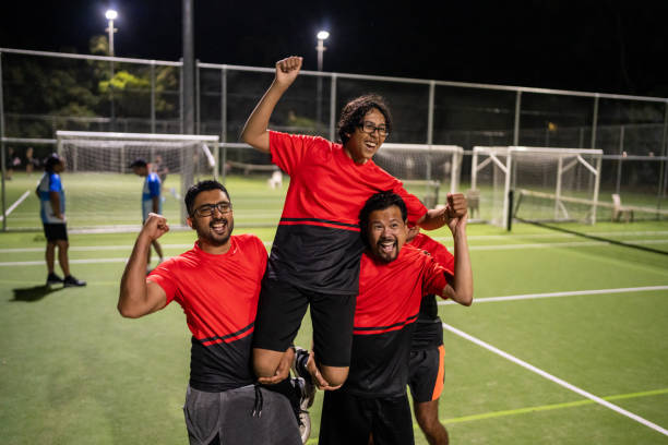 Soccer Players Carrying Teammate with Pride