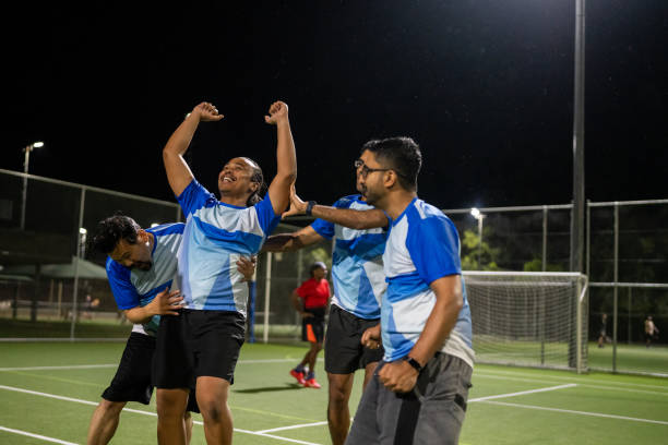 istock Soccer Team Celebrating a Goal 2200056420